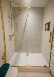 a shower with a white tub in a bathroom at StayPoint in Eastbourne +7 photos