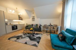 a living room with a blue couch and a table at StayPoint in Eastbourne