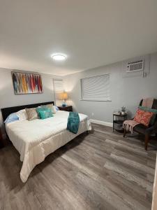 a bedroom with a large bed and a chair at Relaxing 1BR Apartment in Ormond Beach Large Patio in Ormond Beach
