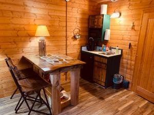 a kitchen with a table and a sink in a cabin at Fancy Fireflies Cabin in Hayward