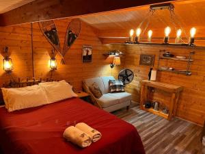 a bedroom with a bed and a chair in a room at The Timberjack in Hayward