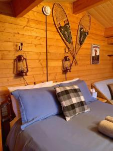 a bedroom with a bed with two lights on the wall at The Timberjack in Hayward +23 photos