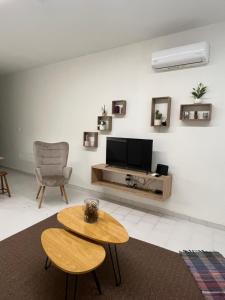 a living room with a tv and a table at Jimilio 1 in Spata