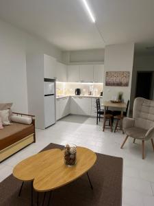 a living room with a table and a kitchen at Jimilio 1 in Spata