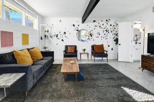 a living room with a couch and a table at Ocotillo Art Bungalow in Palm Springs
