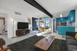 a living room with a couch and a table at Ocotillo Art Bungalow in Palm Springs