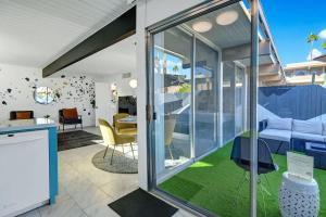 a kitchen and living room with sliding glass doors at Ocotillo Art Bungalow in Palm Springs +22 photos