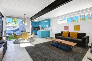 a living room with a couch and a table at Ocotillo Art Bungalow in Palm Springs