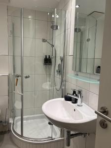 a white bathroom with a shower and a sink at Goodie Room I Apartment I Würzburg Estenfeld in Estenfeld