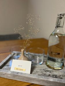 a bottle of water and two glasses on a tray at Goodie Room I Apartment I Würzburg Estenfeld in Estenfeld