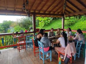 a group of people sitting at a table on a deck at Jaibaná Spa in Támesis