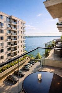 a balcony with a table and a view of the water at Solid Residence Apartamente in Mamaia