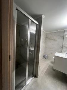 a bathroom with a shower and a sink at Jimilio 2 in Spata +11 photos