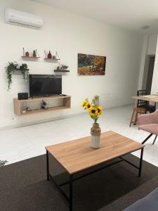 a living room with a vase of flowers on a coffee table at Jimilio 2 in Spata