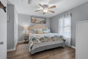 a bedroom with a bed and a ceiling fan at Grand Caribbean East Poolside Palms in Pensacola +41 photos