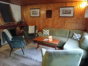 a living room with a couch and chairs at Chata Ružín nad Vodou in Margecany +16 photos
