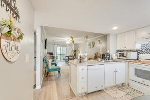 a kitchen with white cabinets and a dining room at 7 Mi to Downtown Fun! Spacious Augusta Condo in Augusta