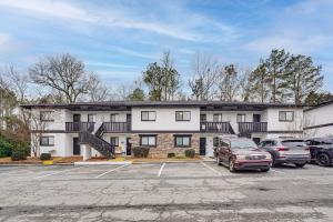 a building with cars parked in a parking lot at 7 Mi to Downtown Fun! Spacious Augusta Condo in Augusta