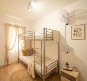 a bedroom with two bunk beds and a fan at Apartalux Playa Diva in Grao de Castellón +46 photos