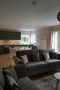 a living room with a couch and a kitchen at McGinns Cottage in Kilcormac