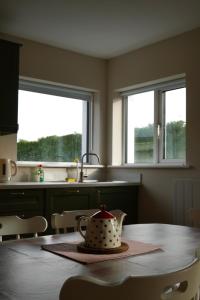 a kitchen with a table with a tea pot on it at McGinns Cottage in Kilcormac