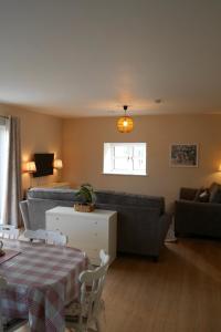 a living room with a table and a couch at McGinns Cottage in Kilcormac +21 photos