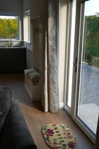 a living room with a large window and a rug at McGinns Cottage in Kilcormac
