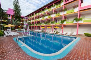 a pool in front of a hotel at Decameron Los Cocos - All Inclusive in Rincon de Guayabitos