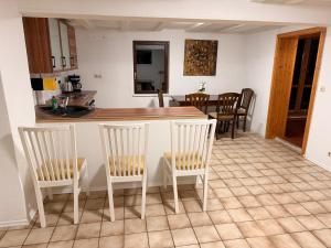a kitchen with two chairs and a table with a counter at Monteur Darius in Spiesheim +2 photos