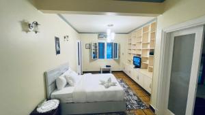 a bedroom with a bed with a flower on it at Stay Ra3 Suites in Cairo