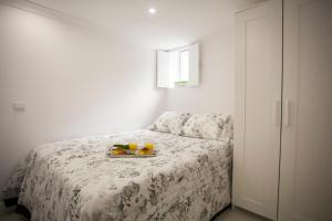 a bedroom with a bed with a tray of fruit on it at Light of Lisbon Apartments I in Lisbon
