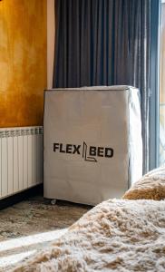 a white box with the word flexed on it in a bedroom at New Gudauri Atrium 218 in Gudauri