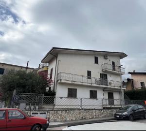 a red car parked in front of a white building at DR HOUSE in Airola