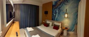 a bedroom with a large bed with red pillows at Çalcalar Otel in Ula
