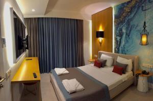 a bedroom with a large bed and a yellow table at Çalcalar Otel in Ula