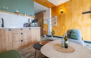 a kitchen with a table and two bottles of wine at New Gudauri Atrium 218 in Gudauri