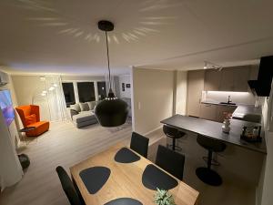a kitchen and living room with a table and chairs at Langhaugen - Kabelvåg in Kabelvåg