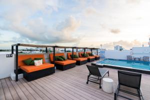 a rooftop deck with couches and a swimming pool at Upsun Hotel in Miami Beach
