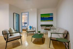 a living room with chairs and a table and a piano at Villa Esterito - La Paz Baja California Sur in La Paz
