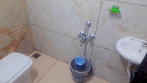 a bathroom with a toilet and a sink at Lazars homestay in Fort Kochi