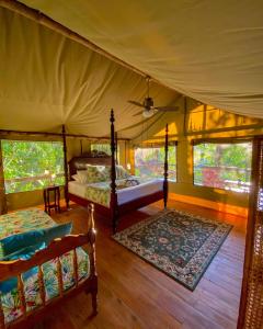 a bedroom with two beds in a tent at Colina Secreta - Glamping and Villas in Puerto Viejo