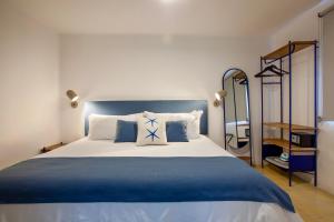 a bedroom with a blue and white bed and a mirror at Villa Esterito - La Paz Baja California Sur in La Paz +45 photos