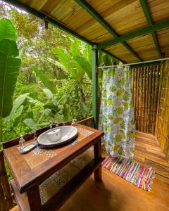 a bathroom with a sink on a porch at Colina Secreta - Glamping and Villas in Puerto Viejo +32 photos
