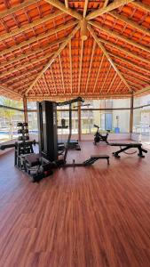 a gym with several treadmills and exercise bikes in it at Brisa Rooftop Vistamar -Apartamento à beira mar com jacuzzi in Luis Correia