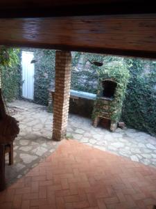 an outside view of a patio with a stone fireplace at Pousada Barracuda Pipa in Pipa