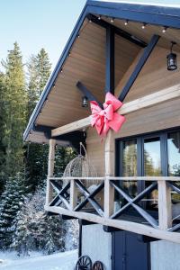 a house with a bow on the front of it at Котедж Rest Hill in Vorokhta