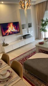 a living room with a fire on the wall at Luxury 127m Apartment in Jardins de Carthage with Balcony, Private Parking & Prime Location in Sidi Daoud
