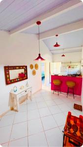 a kitchen and living room with a red island at Casa Praiana Búzios in Búzios