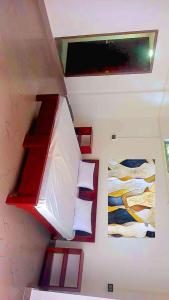 a room with two beds and a window in a room at Devagram Guest house in Dergaon