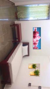 a room with a staircase with two plants on the wall at Devagram Guest house in Dergaon